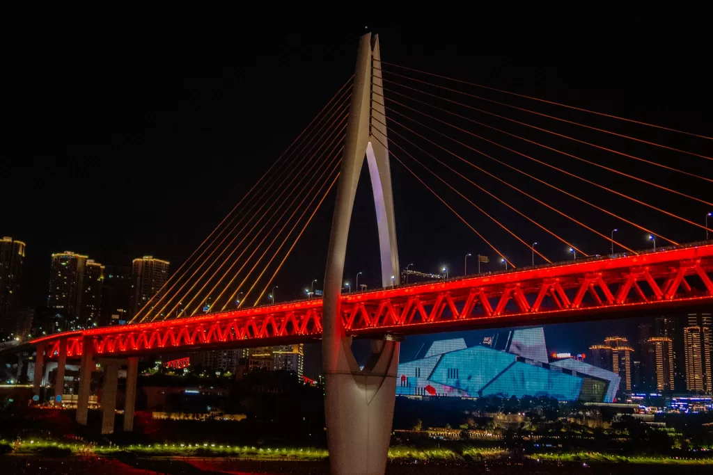 Red lit up bridge at night in Chongqing