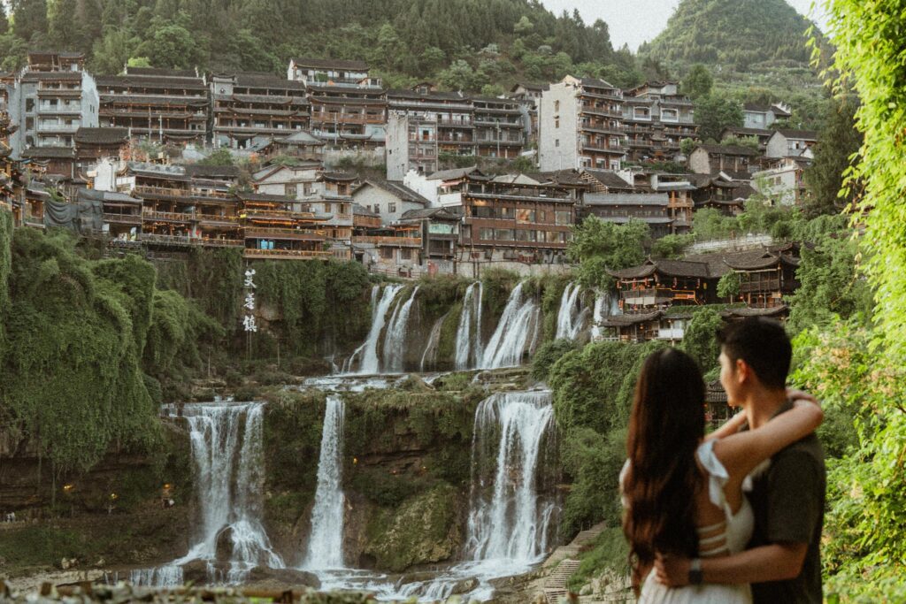 Angelia and Chris in front of famous waterfall at Furong Ancient Town