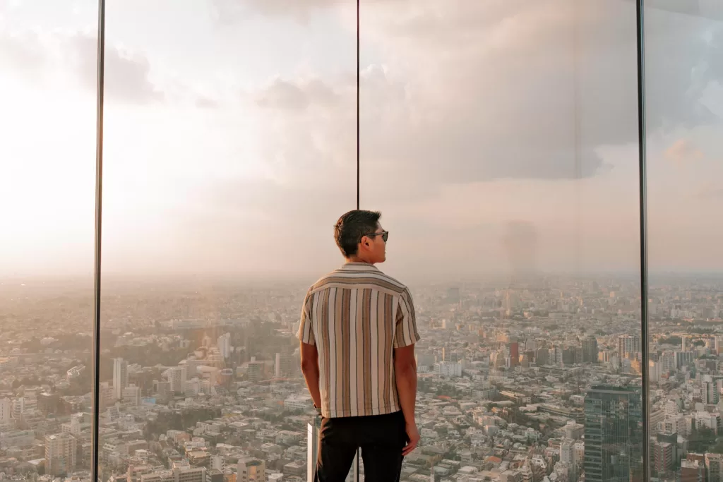 Chris standing in front of the glass at Shibuya Sky