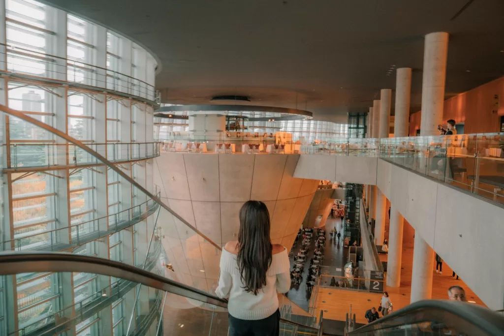 Angelia going down the escalator at the National Art Center
