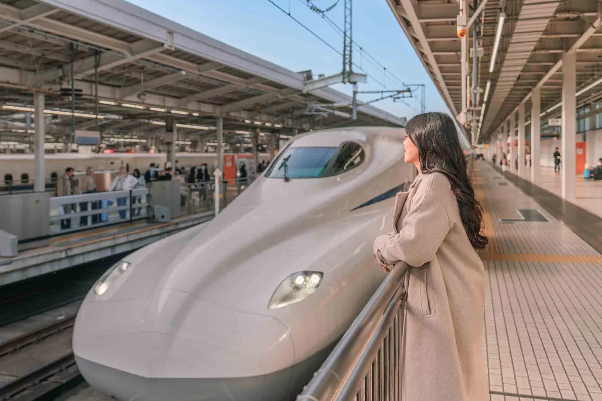 Angelia standing in front of a Shinkansen train in Japan
