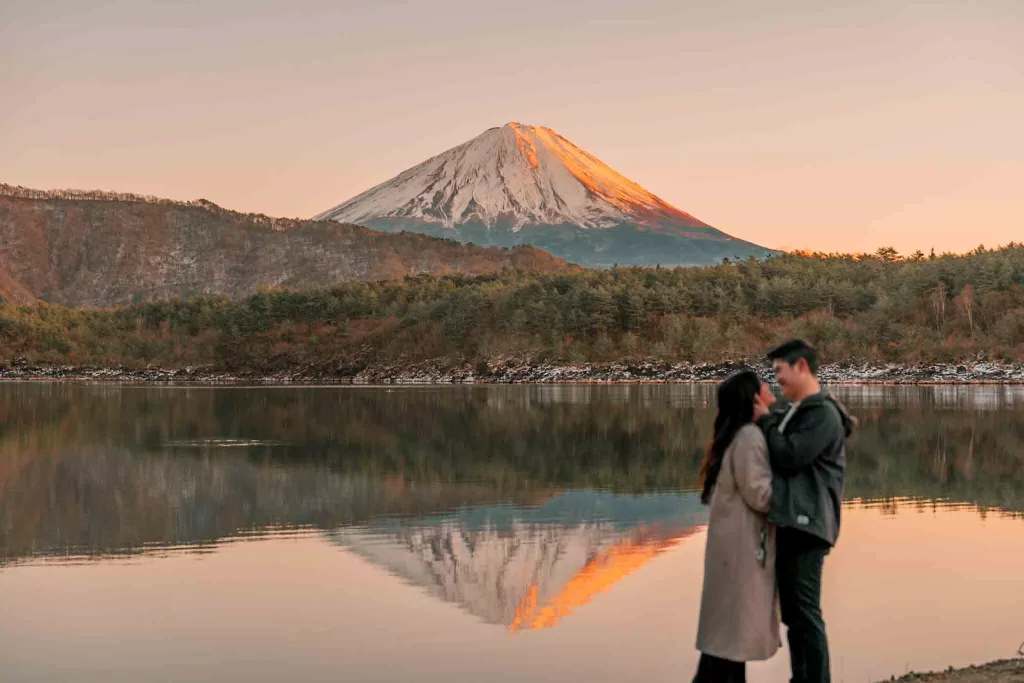 Chris and Angelia facing each other in front of Mt. Fuji at Saiko Nenba-hama