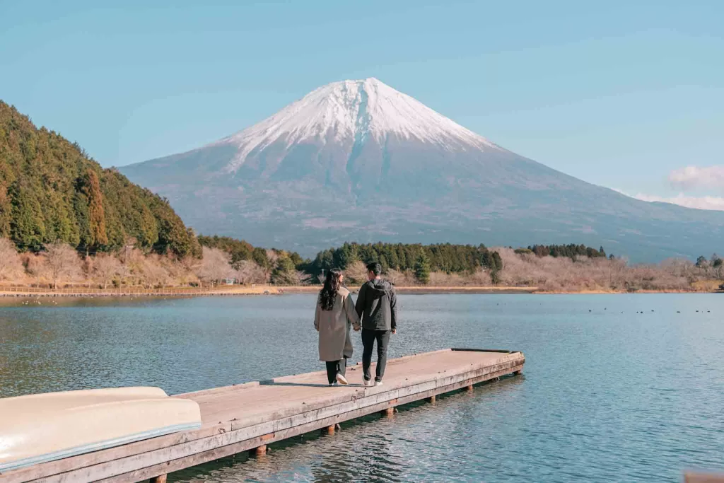 Chris and Angelia facing Mt. Fuji on a small dock at Lake Tanuki