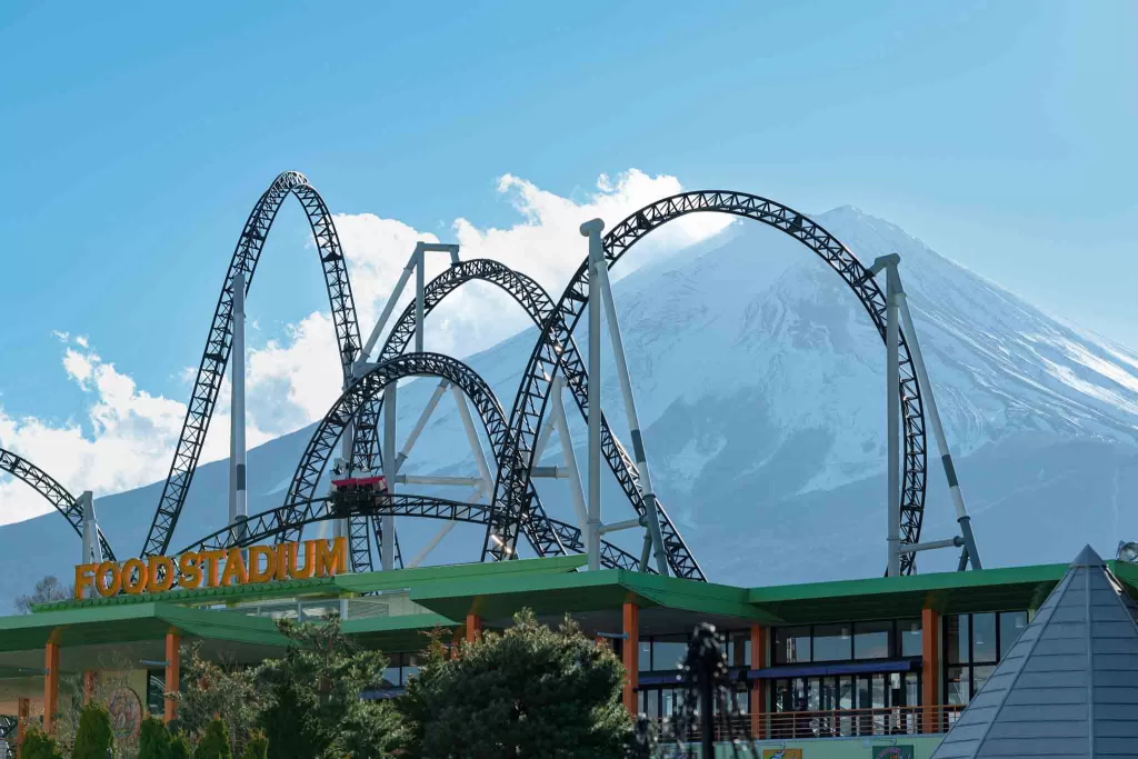 A ride at Fuji-Q Highland amusement park in front of Mt. Fuji