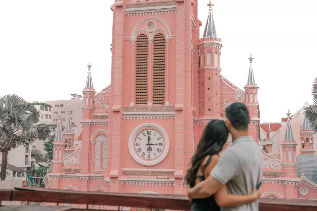 Angelia & Chris hugging on the rooftop of Ola Hale in front of Tan Dinh Catholic Church